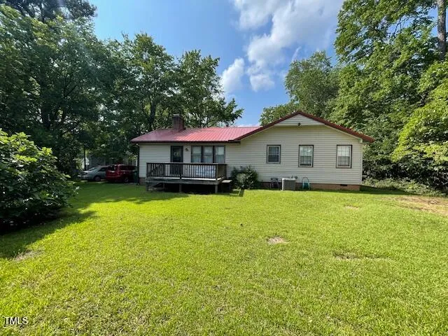 a front view of a house with yard and green space