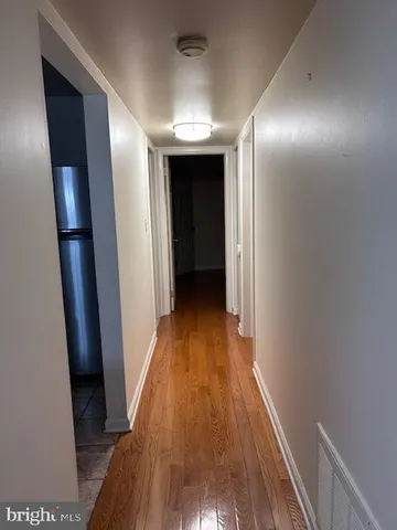 a view of hallway with wooden floor