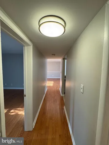 a view of a hallway and wooden floor