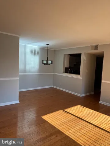 a view of a livingroom with wooden floor and staircase