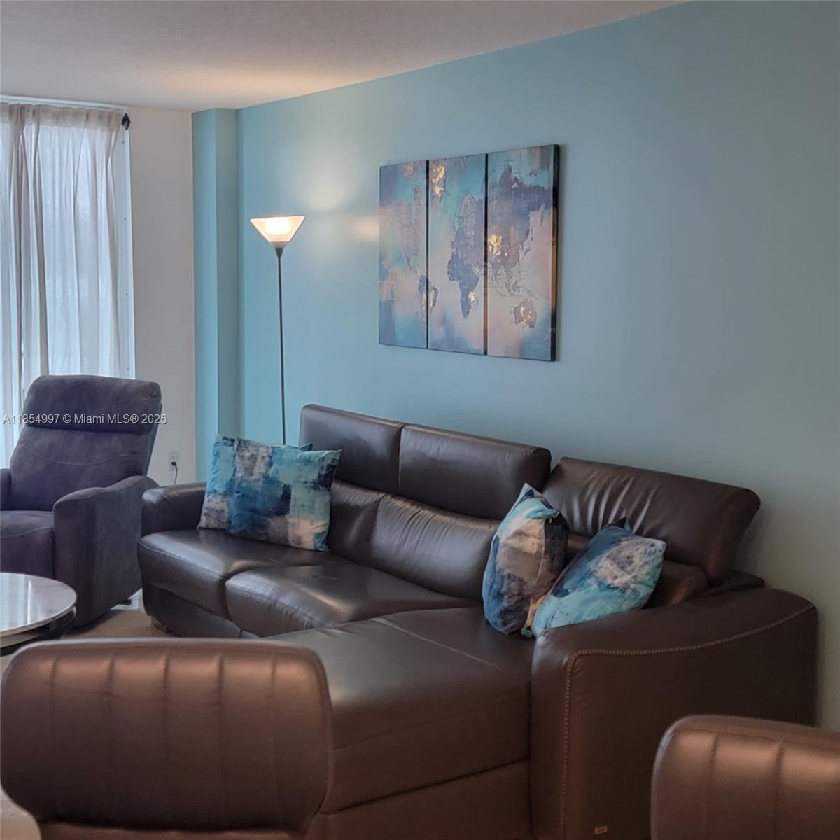 6917 Collins Avenue, Unit 408 Miami Beach, FL 33141 - Photo 11 of 39 a living room with furniture and a couch