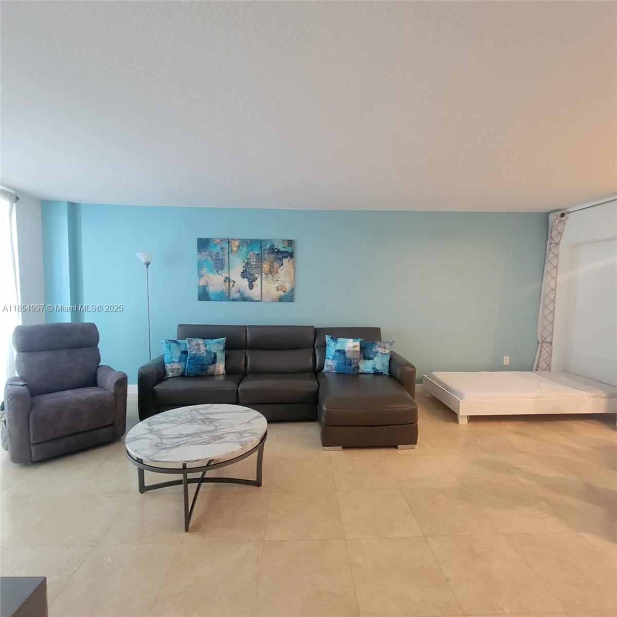 6917 Collins Avenue, Unit 408 Miami Beach, FL 33141 - Photo 12 of 39 a living room with furniture and a couch