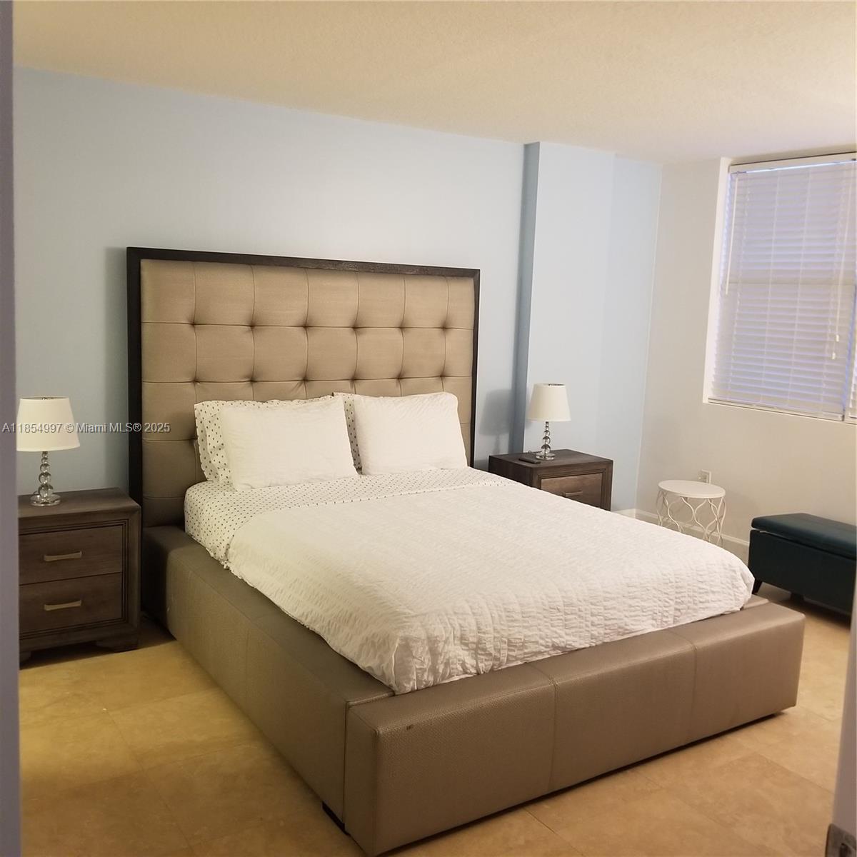 6917 Collins Avenue, Unit 408 Miami Beach, FL 33141 - Photo 18 of 39 a bedroom with a bed and window