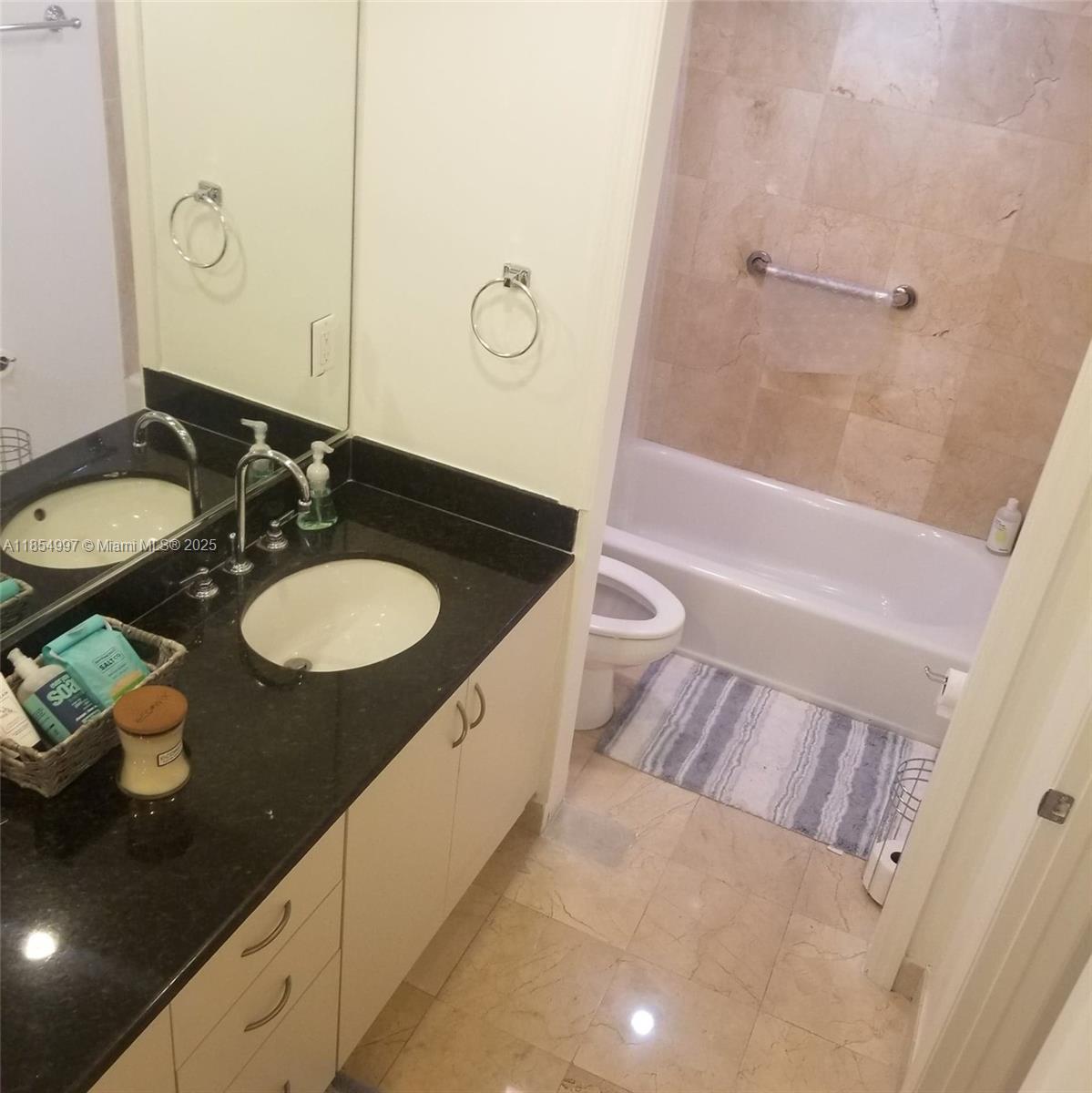 6917 Collins Avenue, Unit 408 Miami Beach, FL 33141 - Photo 20 of 39 a bathroom with a granite countertop sink and a mirror