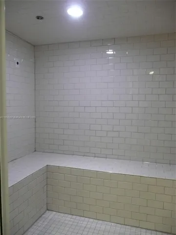 a bathroom with a shower and a glass door