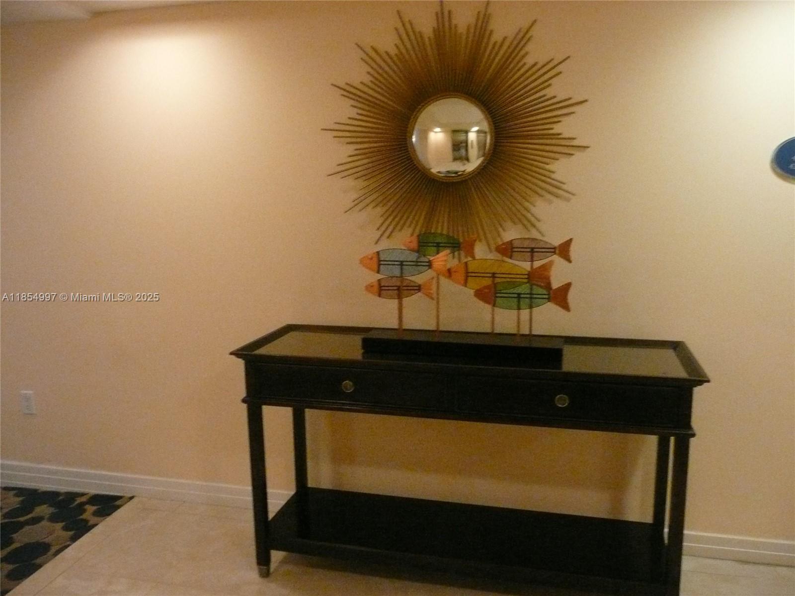 6917 Collins Avenue, Unit 408 Miami Beach, FL 33141 - Photo 29 of 39 a room with a table and a chair