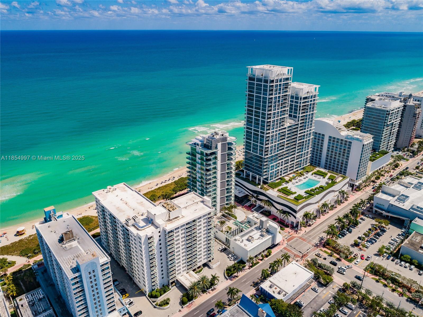 6917 Collins Avenue, Unit 408 Miami Beach, FL 33141 - Photo 35 of 39 a view of a roof deck with two chairs and a yard