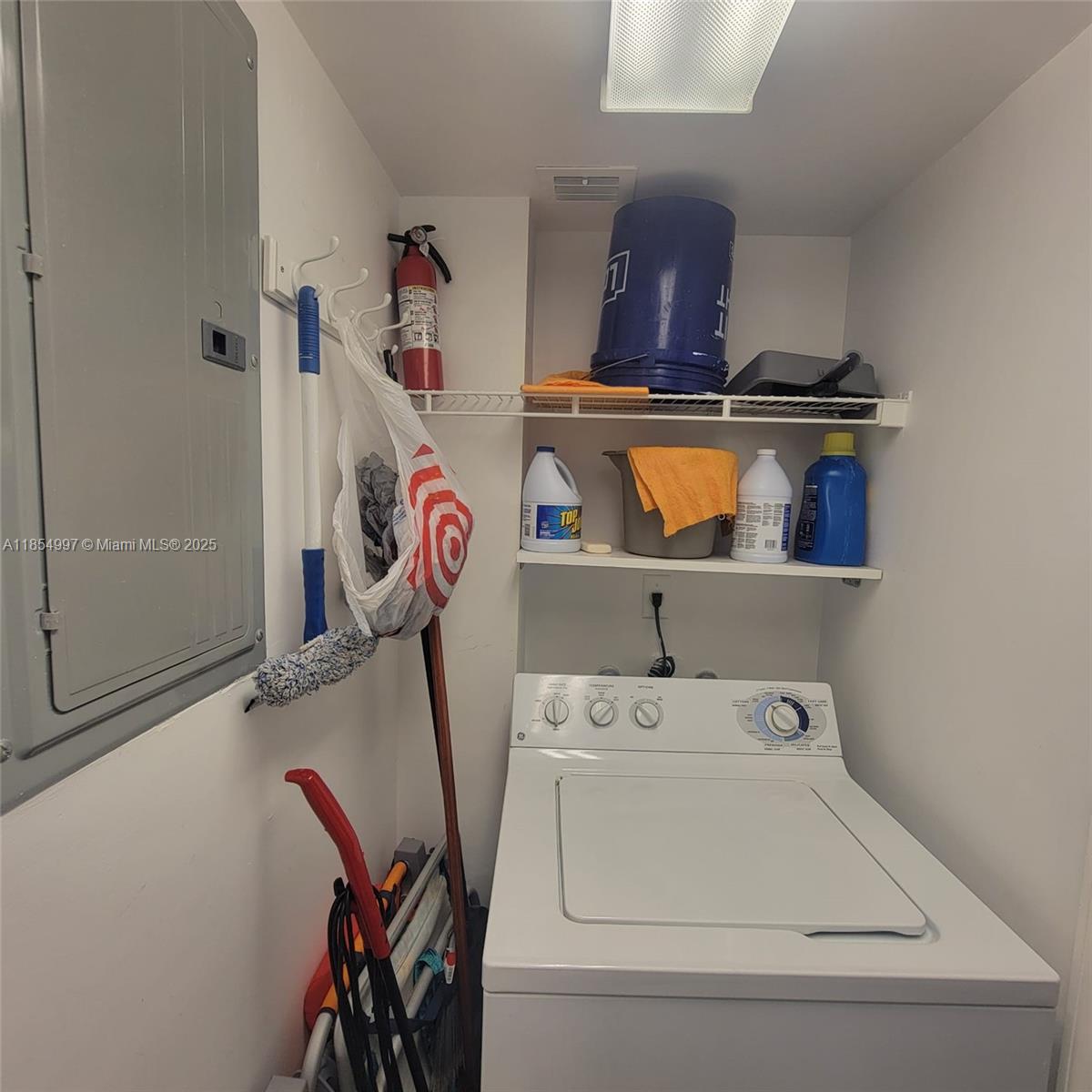 6917 Collins Avenue, Unit 408 Miami Beach, FL 33141 - Photo 9 of 39 a utility room with dryer and washer