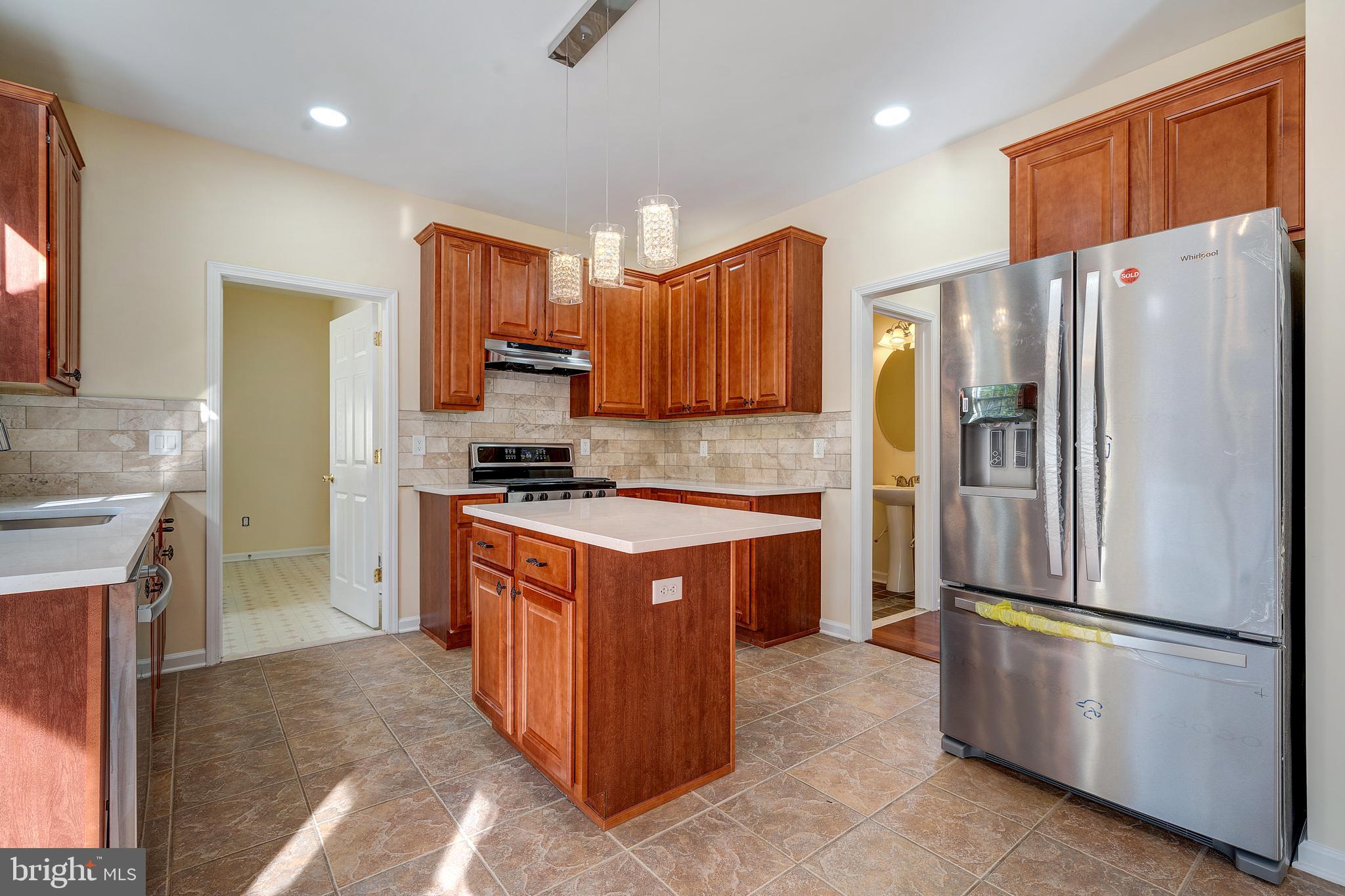 23 Homestead Drive Pemberton, NJ 08068 - Photo 25 of 40 a kitchen with stainless steel appliances granite countertop a refrigerator a stove a sink and a refrigerator