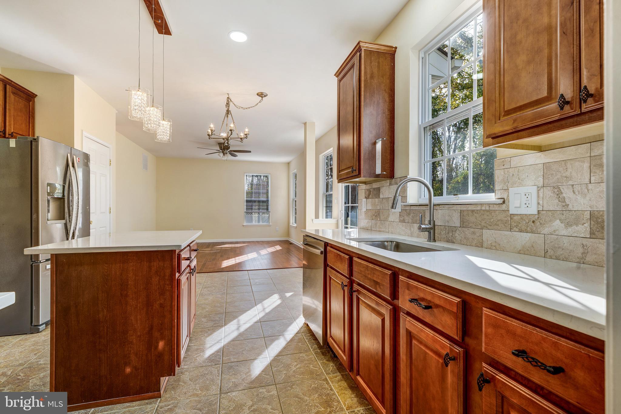 23 Homestead Drive Pemberton, NJ 08068 - Photo 26 of 40 a kitchen with stainless steel appliances granite countertop a sink and a refrigerator