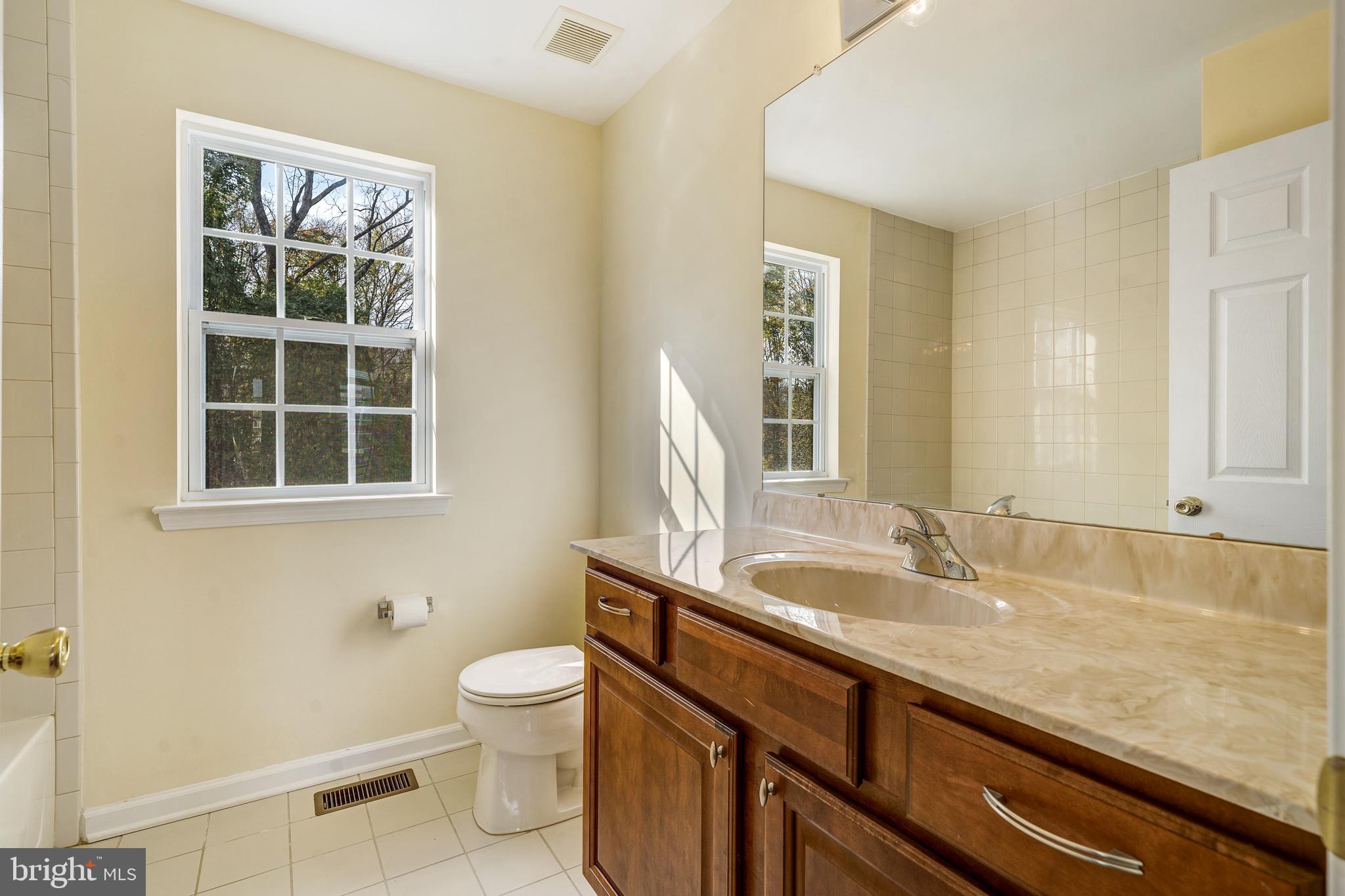 23 Homestead Drive Pemberton, NJ 08068 - Photo 28 of 40 a bathroom with a granite countertop sink a toilet and a window