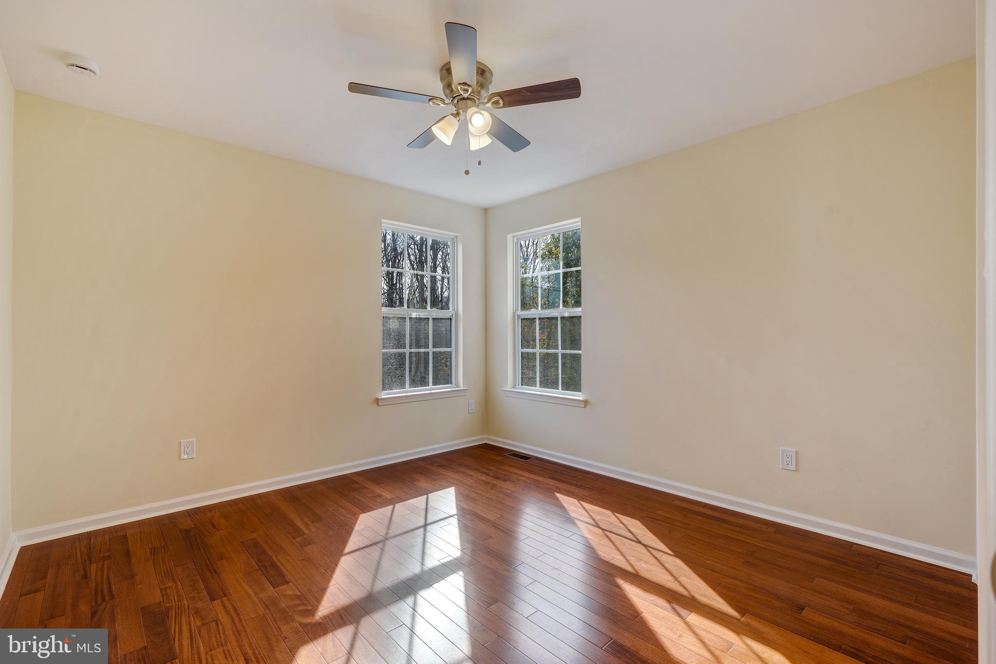 23 Homestead Drive Pemberton, NJ 08068 - Photo 29 of 40 a view of an empty room with a window and wooden floor