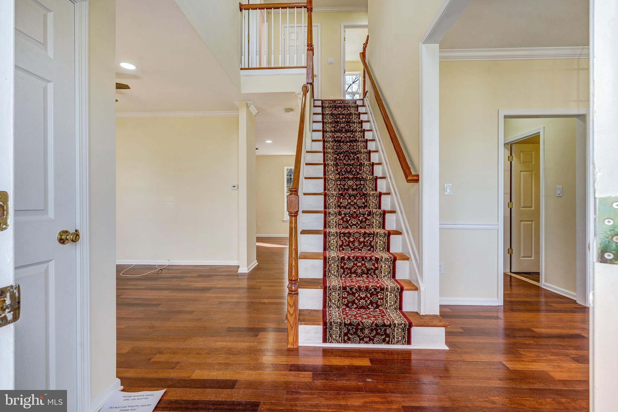 23 Homestead Drive Pemberton, NJ 08068 - Photo 35 of 40 a view of a hallway with wooden floor and stairs