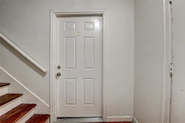 a view of front door with wooden floor