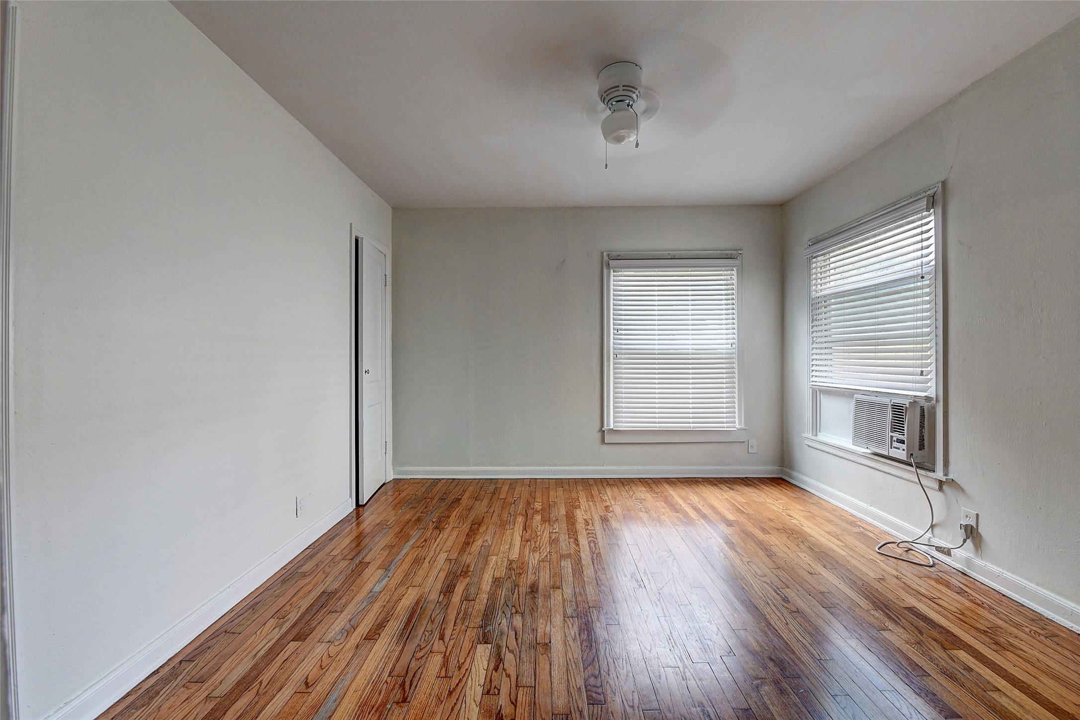 2509 Shakespeare Street, Unit 4 Houston, TX 77030 - Photo 14 of 16 a view of empty room with wooden floor and fan