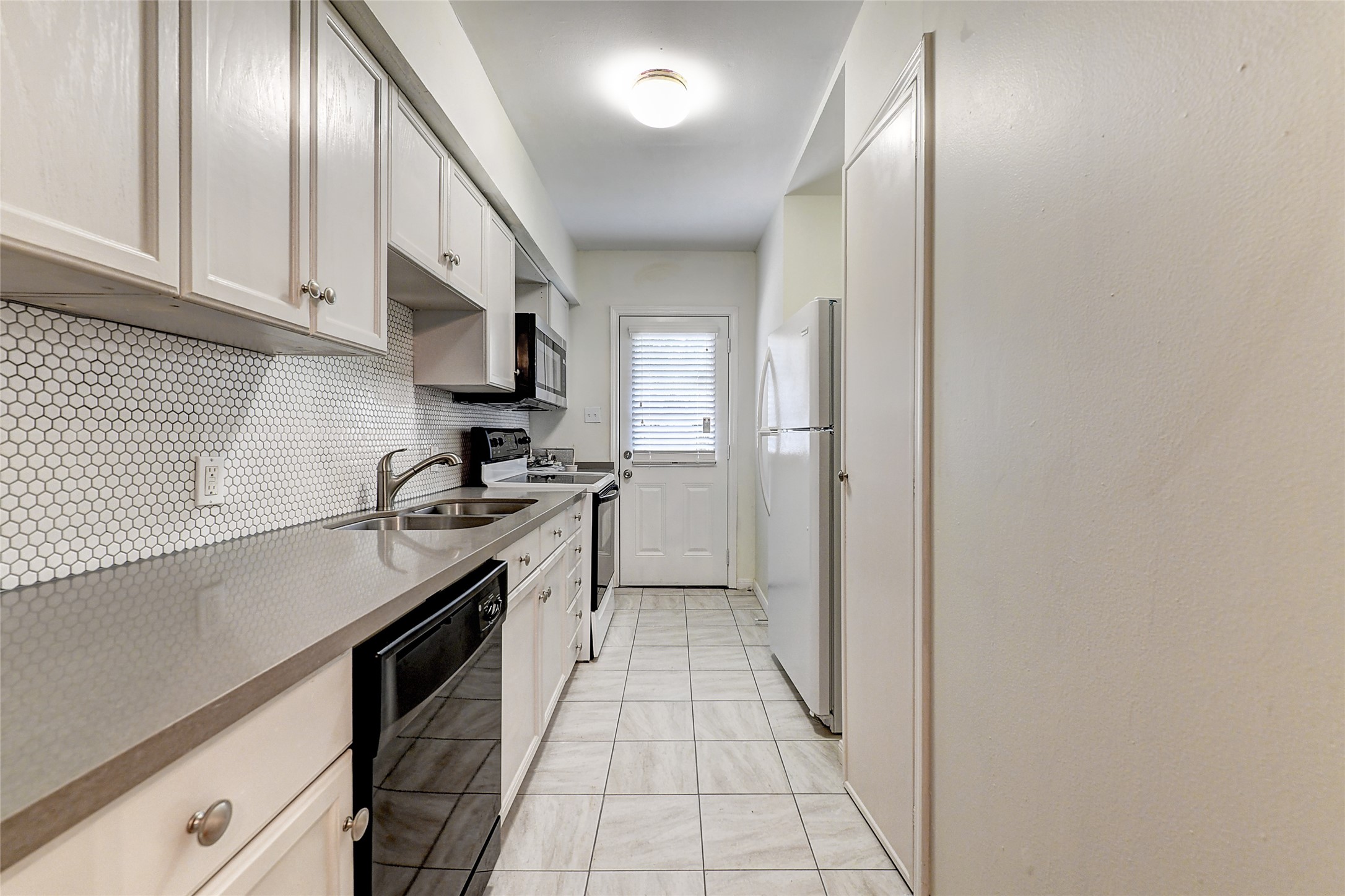 2509 Shakespeare Street, Unit 4 Houston, TX 77030 - Photo 16 of 16 a kitchen with stainless steel appliances granite countertop a sink stove and cabinets