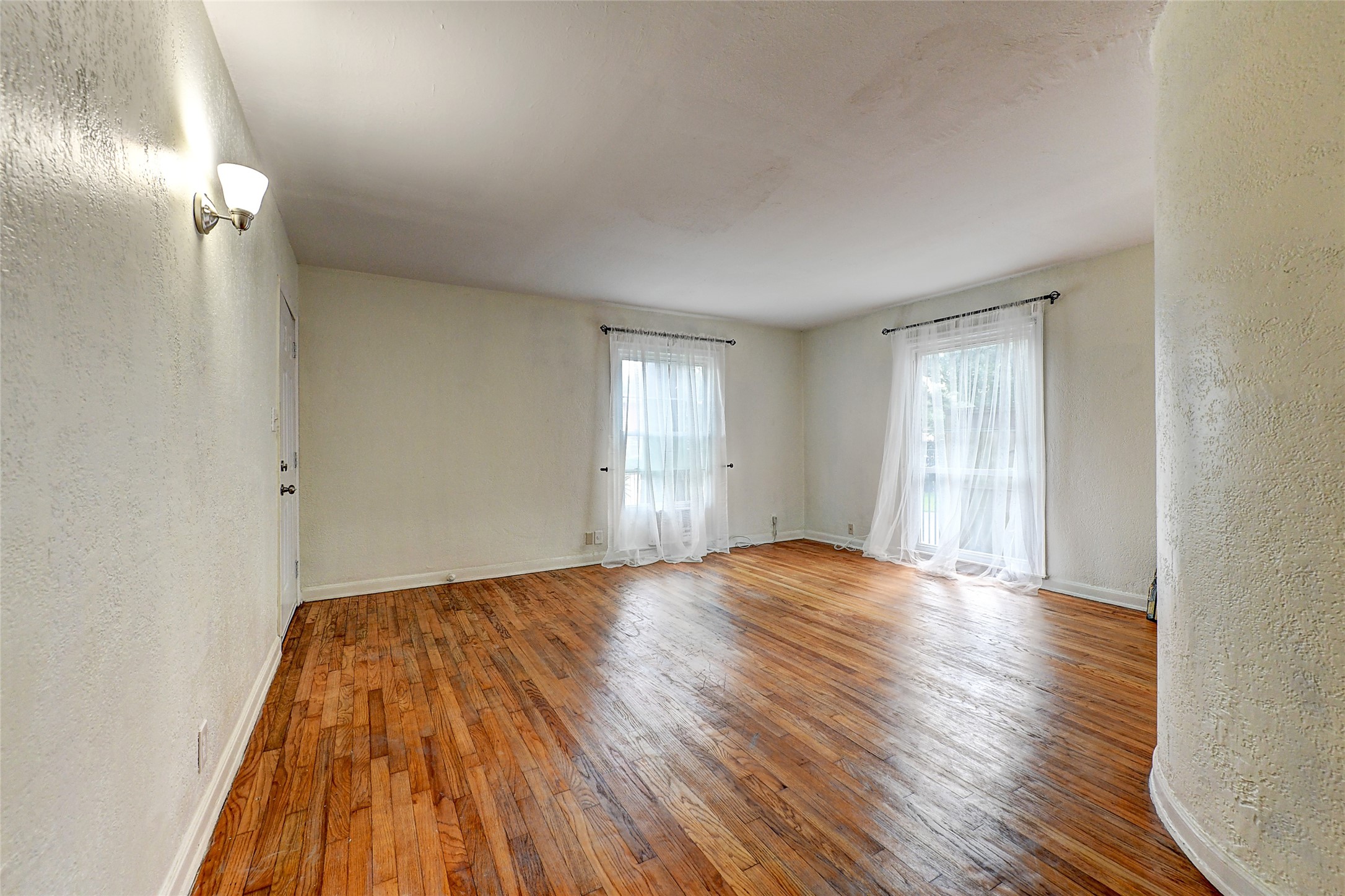 2509 Shakespeare Street, Unit 4 Houston, TX 77030 - Photo 6 of 16 a view of empty room with wooden floor and fan