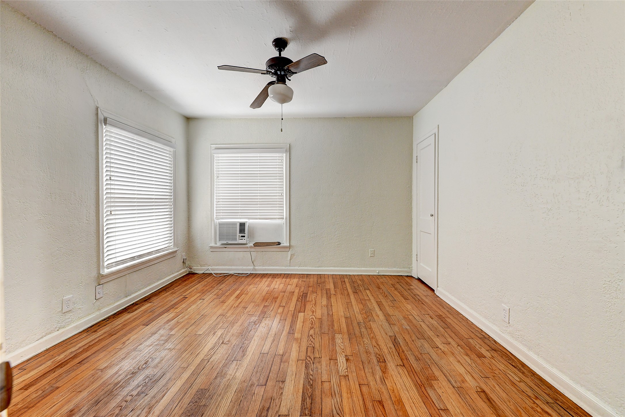 2509 Shakespeare Street, Unit 4 Houston, TX 77030 - Photo 8 of 16 a view of empty room with wooden floor and fan