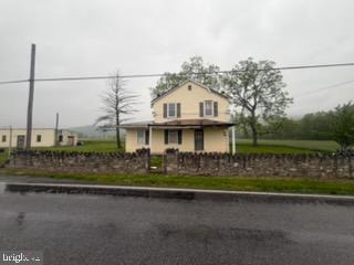 13804 Mercersburg Road Clear Spring, MD 21722 - Photo 27 of 48 a view of a white house with large windows and a small yard