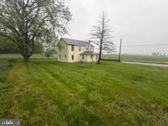 13804 Mercersburg Road Clear Spring, MD 21722 - Photo 29 of 48 a view of a house with a big yard and a large tree