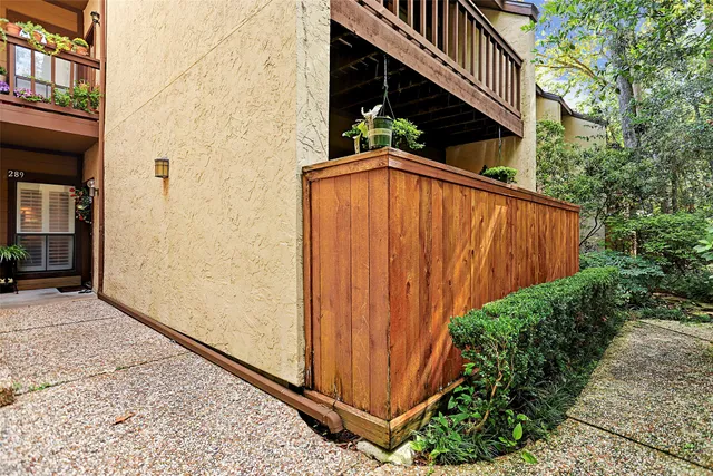 a view of a house with backyard and wooden fence