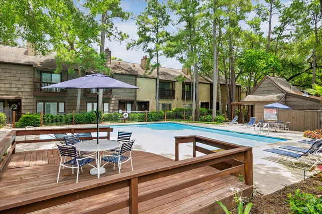 a view of backyard with outdoor seating and trees
