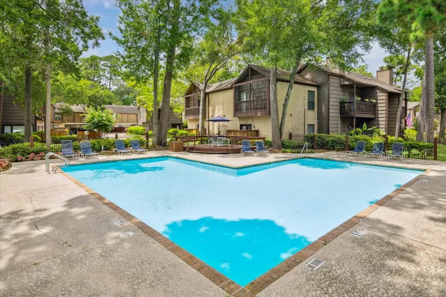 a view of a house with pool and sitting area