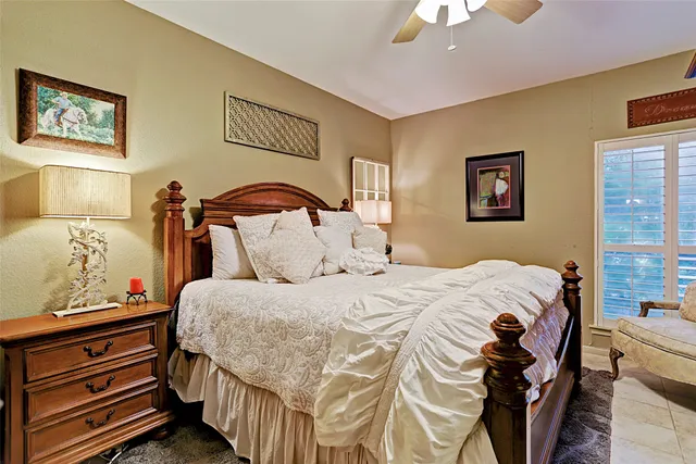 a bedroom with a bed and a painting on the wall