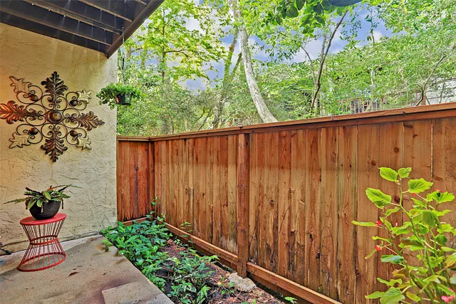a backyard of a house with a garden and plants