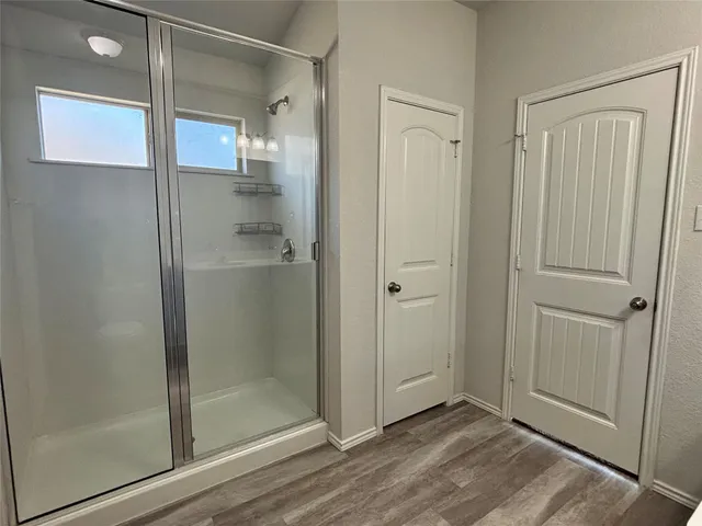 a bathroom with a glass shower door