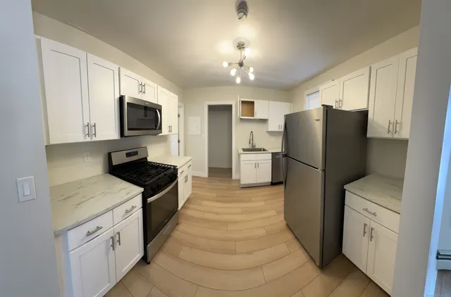 a kitchen with a refrigerator stove and sink