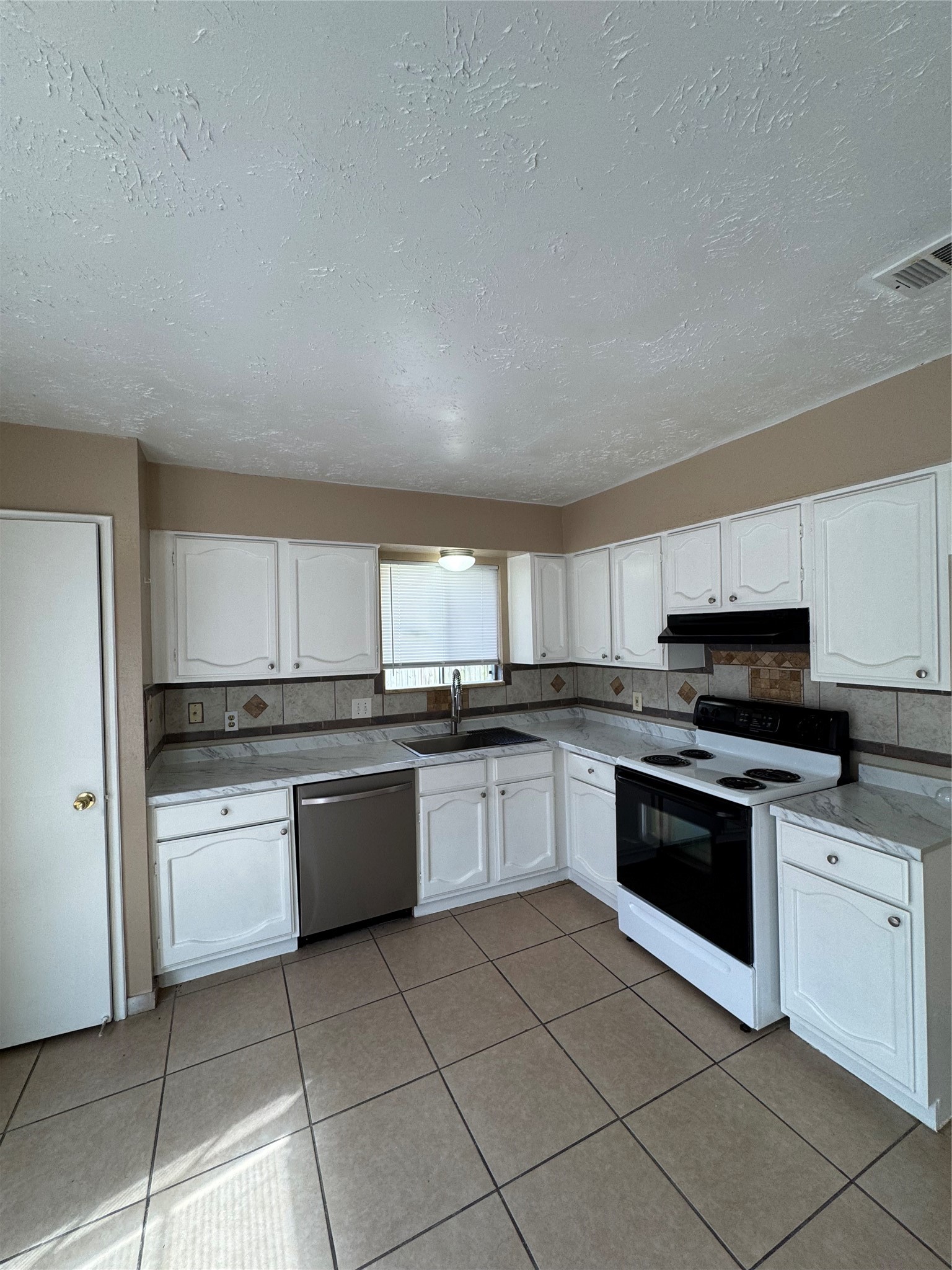 4435 Brookhead Trail Houston, TX 77066 - Photo 5 of 20 a kitchen with a stove top oven and cabinets