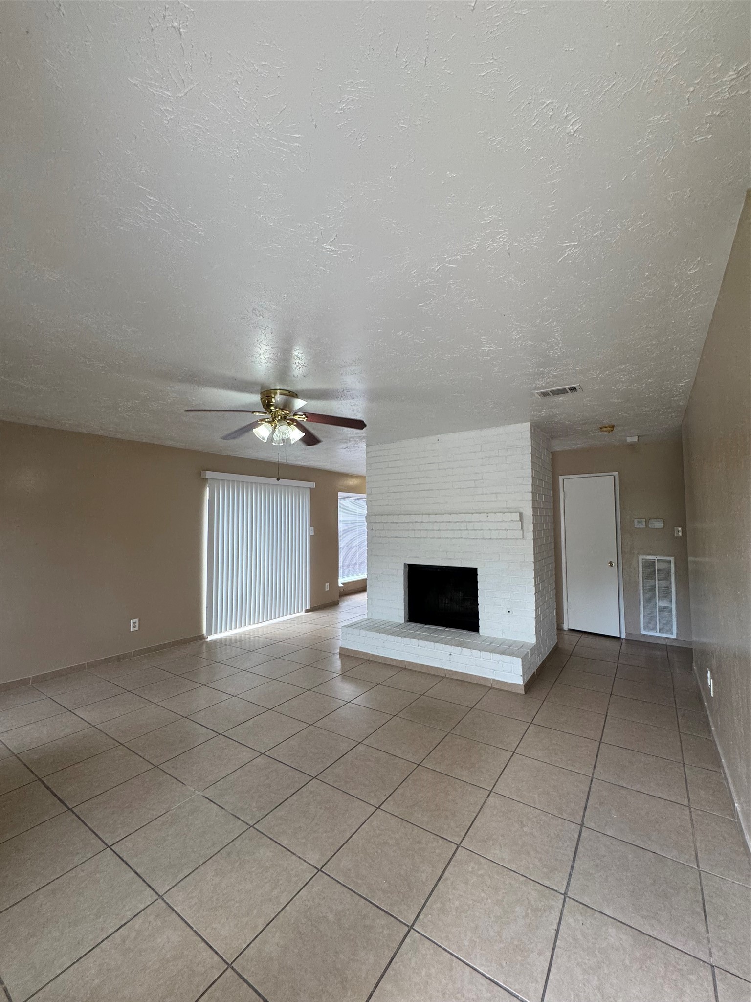4435 Brookhead Trail Houston, TX 77066 - Photo 10 of 20 an empty room with fireplace and windows