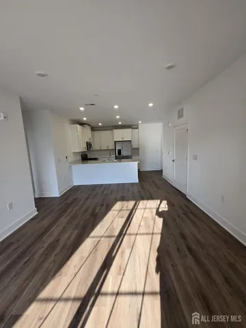 a kitchen with a sink and wooden floor