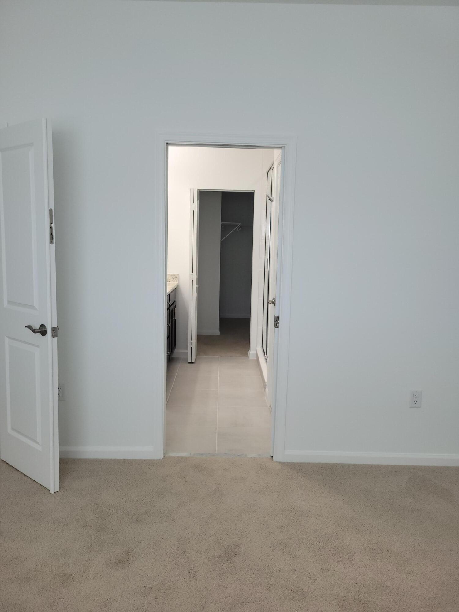 Undisclosed Address Loxahatchee, FL 33470 - Photo 7 of 17 a view of an empty room with closet and a bathroom