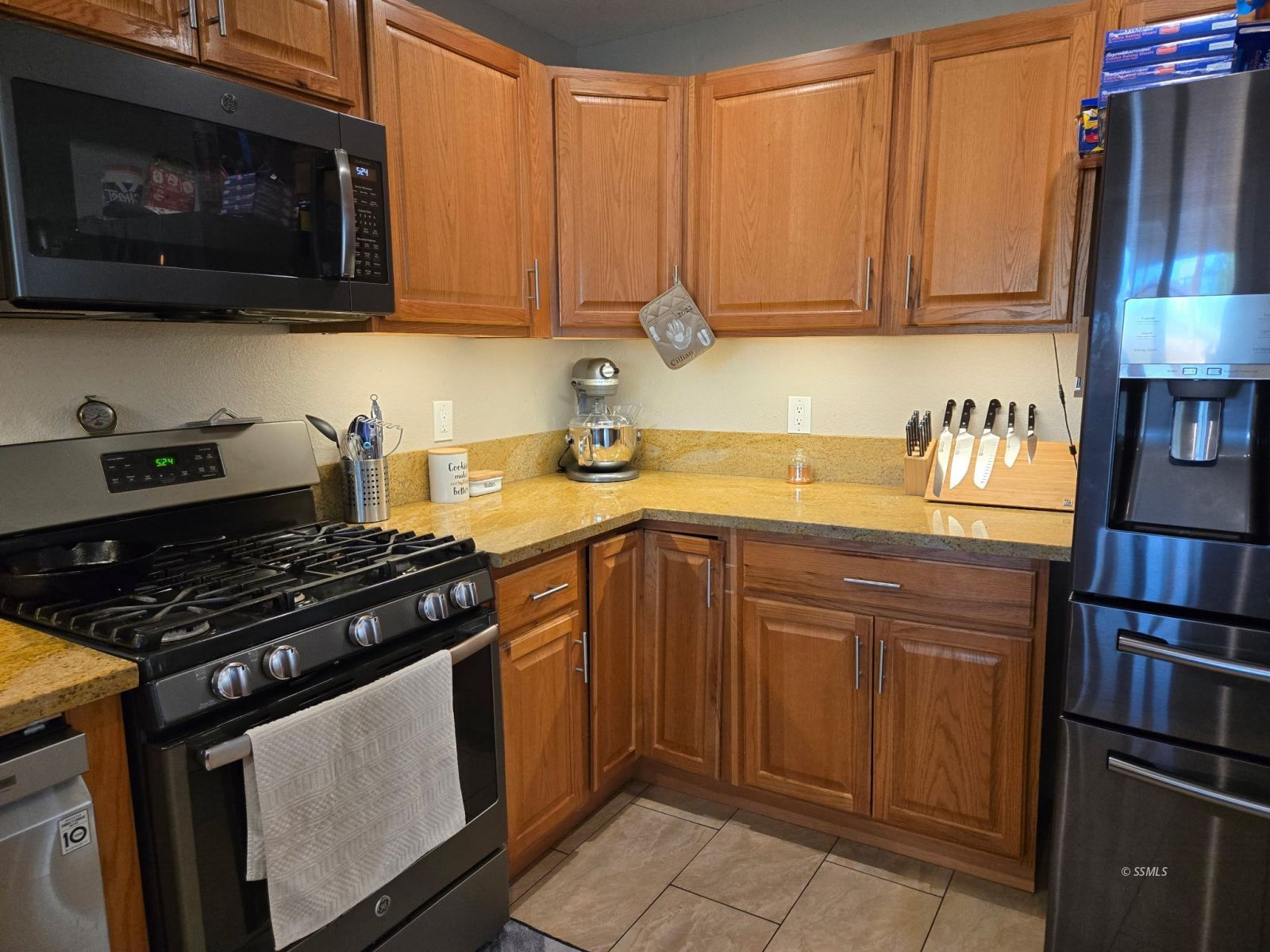 208 South Orchard Street Ridgecrest, CA 93555 - Photo 19 of 26 a kitchen with stainless steel appliances granite countertop a stove and a microwave