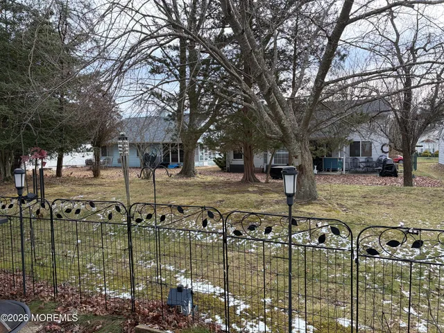 a view of a yard with yellow house