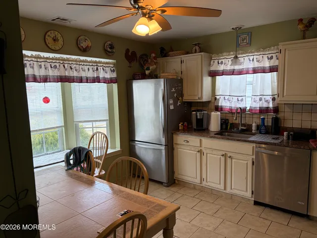 a kitchen with stainless steel appliances granite countertop a refrigerator and a sink