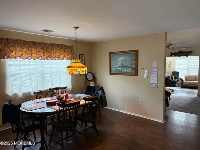 a view of a dining room with furniture and wooden floor