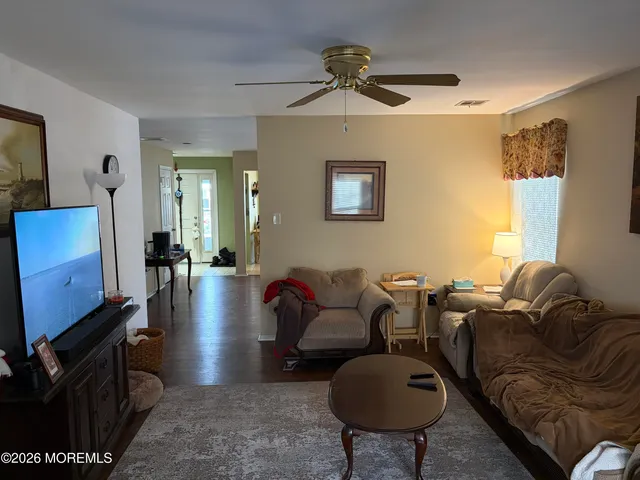 a living room with furniture a couch and a window