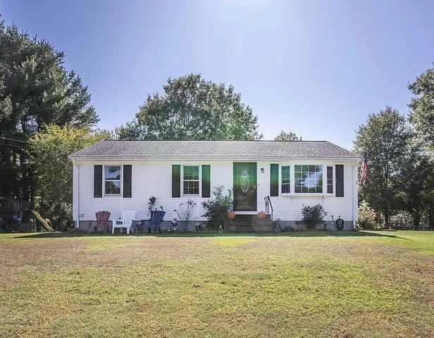 a view of a house with swimming pool and sitting area