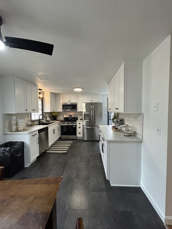 10 Walter Street Norton, MA 02766 - Photo 12 of 33 a large kitchen with cabinets and stainless steel appliances