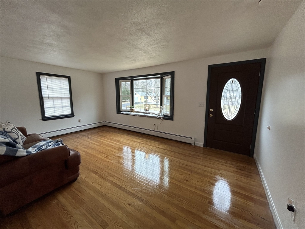 10 Walter Street Norton, MA 02766 - Photo 16 of 33 a living room with wooden floor and a large window