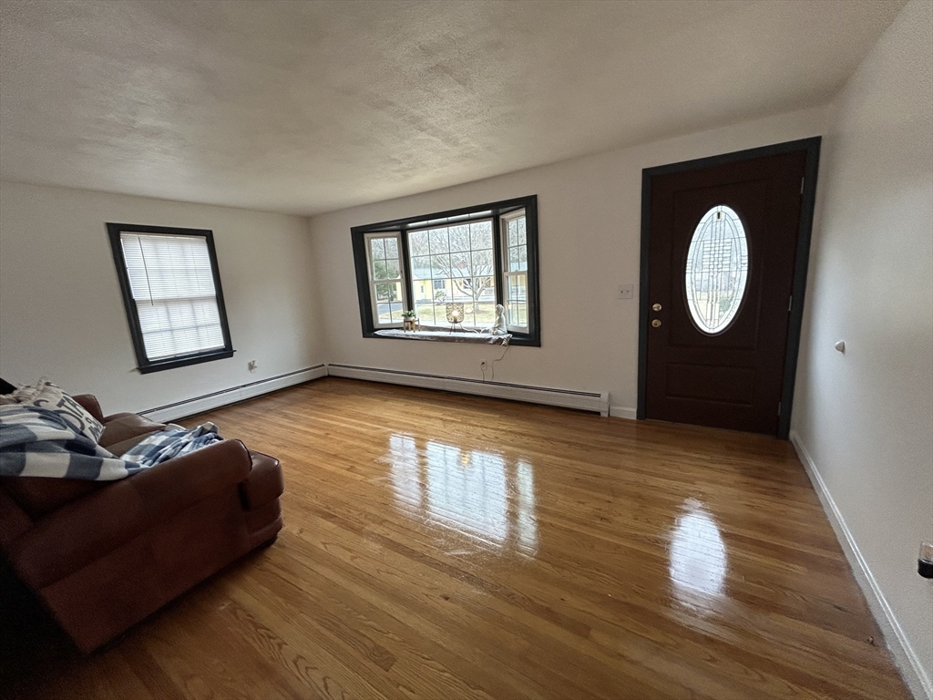 10 Walter Street Norton, MA 02766 - Photo 17 of 33 a living room with furniture and a wooden floor