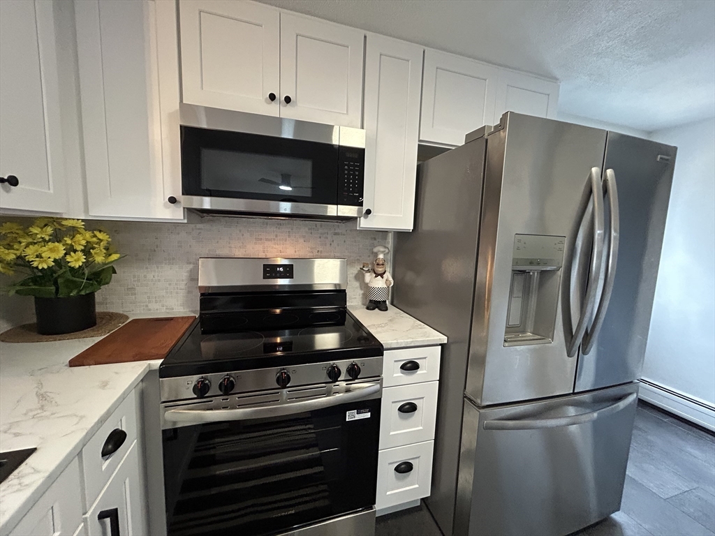 10 Walter Street Norton, MA 02766 - Photo 8 of 33 a kitchen with stainless steel appliances granite countertop a refrigerator stove and microwave
