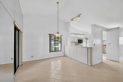 a view of a hallway with entryway and staircase