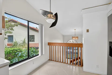 a view of a an entryway dining room and livingroom with furniture wooden floor a chandelier