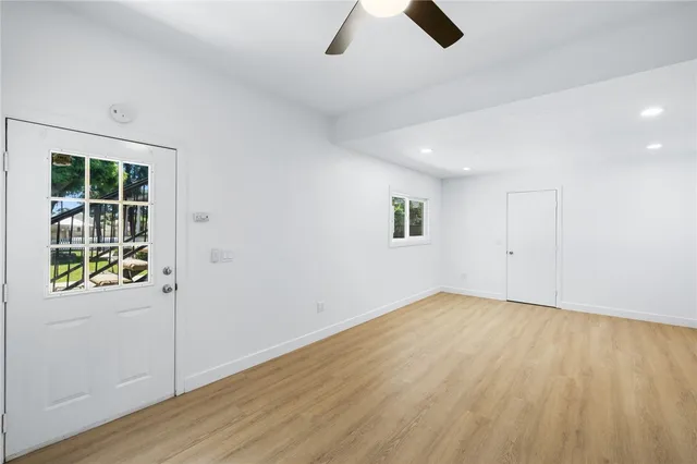 wooden floor in an empty room with a window