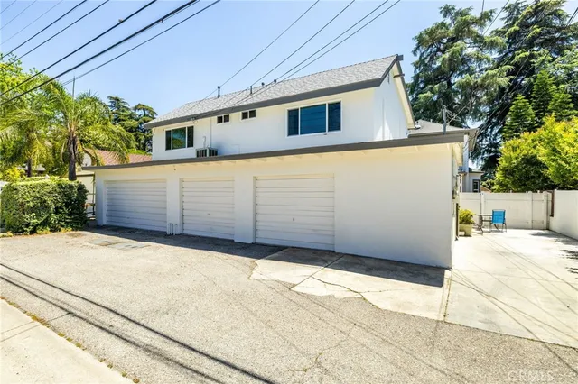 a view of a house with a large tree