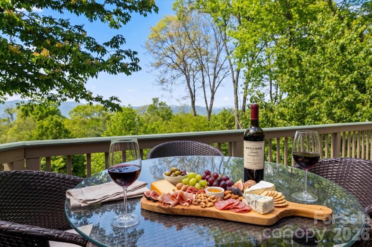 121 Ivy Ridge Road Burnsville, NC 28714 - Photo 3 of 48 a view of a balcony with two chairs and a table